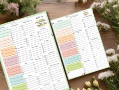 two planner pages sitting on top of a wooden table next to flowers