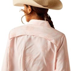 a woman wearing a pink shirt and hat