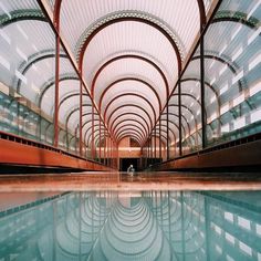 an indoor swimming pool in a large building