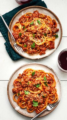 two plates filled with spaghetti and sauce