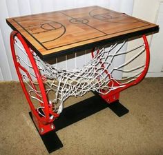 a table made out of basketball hoops on top of carpeted floor next to wall