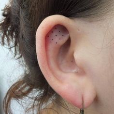 an ear with tiny black dots on it