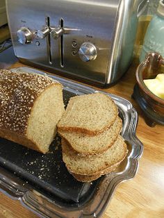 a loaf of bread sitting on top of a metal pan next to a toaster