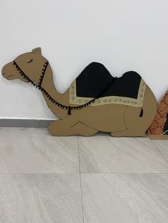 a cardboard camel laying down on the floor