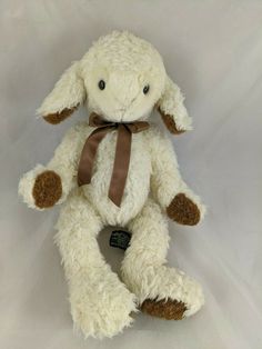 a stuffed animal with a brown bow on its neck