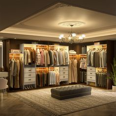 a large closet with clothes hanging on the walls, and a footstool in front of it