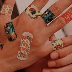 two hands with different designs on their fingers