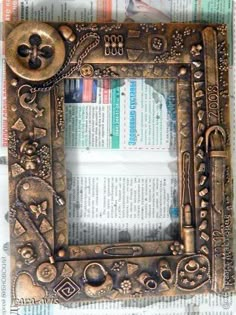 an old photo frame sitting on top of a newspaper