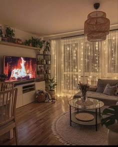 a living room filled with furniture and a flat screen tv sitting on top of a wooden floor