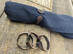 an old pair of scissors sitting on top of a piece of cloth next to it