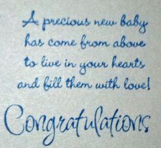 congratulations written in blue ink on a white paper with writing underneath the words,'a precious new baby has come from above to live in your hearts and fill them with love