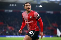 a soccer player is running on the field with his mouth open and eyes wide open