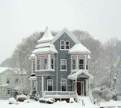 a large house covered in snow on a snowy day