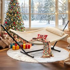 a hammock is set up in front of a christmas tree