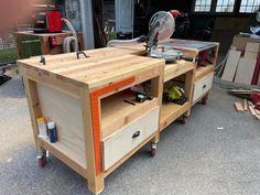 a workbench made out of wood with tools on the top and drawers below