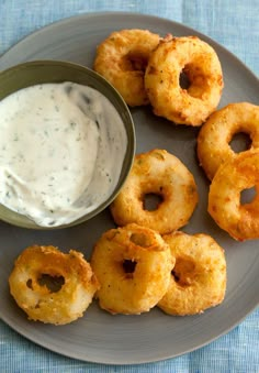 onion rings with ranch dip on a plate