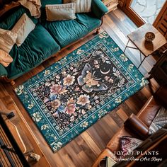 an overhead view of a living room with a green couch and rug on the floor