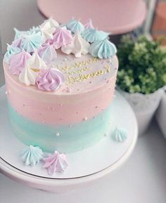 a pink and blue cake sitting on top of a white plate