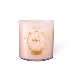 a pink candle with an image of a clock on the front and back of it