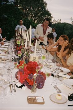 a group of people sitting around a dinner table