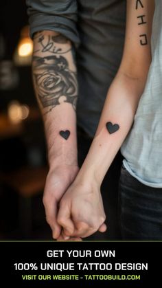 two people holding hands with tattoos on their arms and the words get your own unique tattoo design