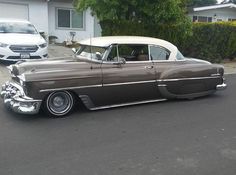 an old car is parked on the street