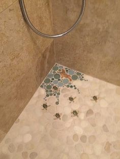 a tiled shower stall with an animal on the floor and bubbles in the bathtub