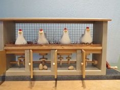 three chickens sitting on top of a wooden shelf