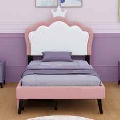 there is a bed with a pink headboard and purple pillows on the floor next to two nightstands