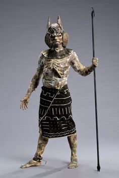 a statue of an egyptian god holding a staff