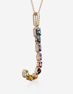 Find DOLCE & GABBANA Rainbow Alphabet J Pendant In Yellow With Multicolor Fine Gems on Editorialist. The yellow gold pendant is illuminated by a veritable rainbow of natural gemstones such as topaz, garnet, amethyst, citrine, peridot and tourmaline. the shades of their colours, dominated by blue, green, purple, red, pink and yellow, evoke the warm atmospheres of Sicily. The multiple shapes of the crystals are also emphasized by the bezels, which alternate twisted thread processing and smooth sur Rainbow Alphabet, Logo Jewelry, Yellow Citrine, Gold Necklace Women, Green Peridot, Swiss Blue Topaz, Yellow Gold Chain, Yellow Gold Pendants, Small Pendant