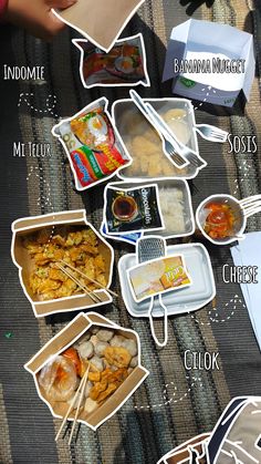 there are many different types of food in the box on the table with chopsticks