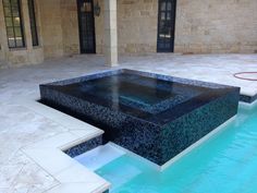 an outdoor swimming pool with steps leading up to it