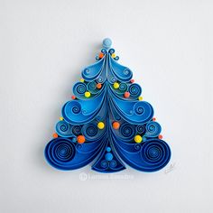 a paper christmas tree with colorful balls on it