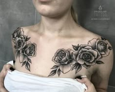 a woman with tattoos on her chest and shoulder