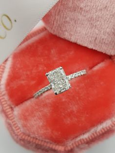 an engagement ring in a red velvet box