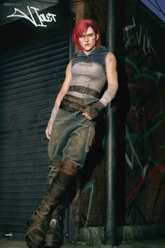 a woman with red hair standing next to a pole