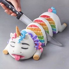 a cake shaped like a unicorn with a knife sticking out of it