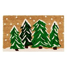 a door mat with three green trees on it and snow flakes all over the ground