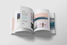 an open book with pictures and text on the page, showing surfers surfing in the ocean