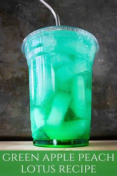 a green drink in a plastic cup with a metal straw sticking out of the top