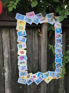 the letter c is made out of stickers and magnets on a wooden fence