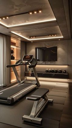 an exercise room with treadmills and television