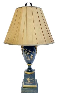 a blue and gold vase with a lamp on it