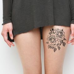 a woman's thigh with flowers on it