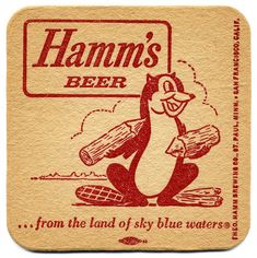 a coaster with a cartoon penguin holding a piece of wood and the words hamm's beer on it