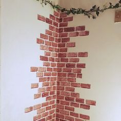 a toilet sitting next to a brick wall with ivy growing on it's side