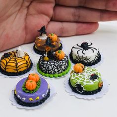 there are many decorated cakes in the shape of witches and spider webs on them