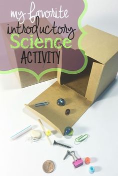 an open cardboard box with scissors and other crafting supplies on the table next to it