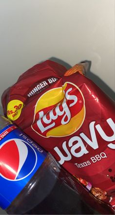 a bag of chips and a bottle of soda